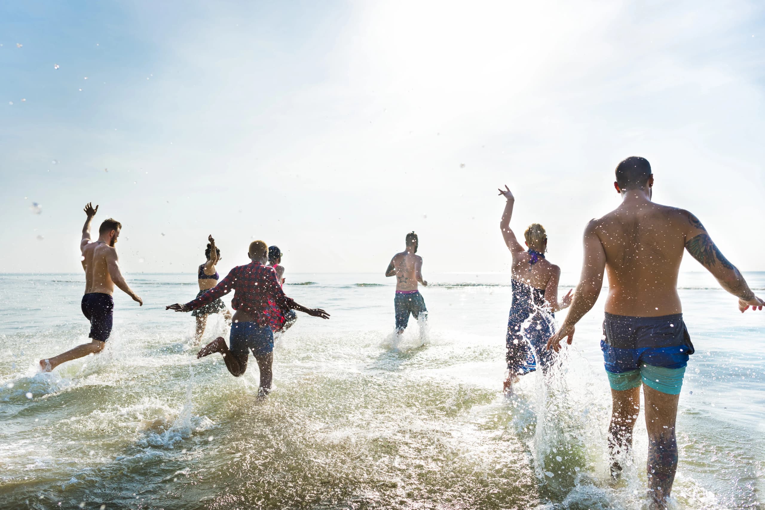People enjoying a sunset beach event by the sea