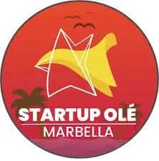 Circular Startup OLÉ Marbella logo with white star, red gradient background, yellow shape and palm tree silhouettes for a startup event in Marbella.
