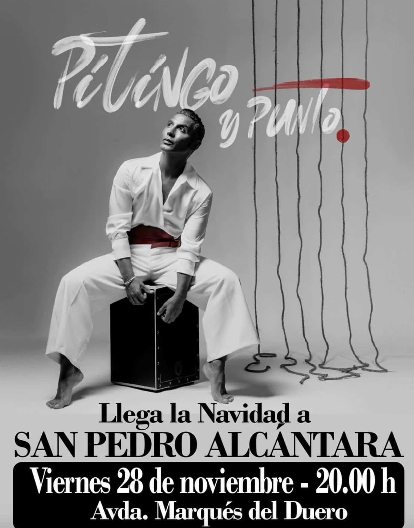 Black-and-white poster for Pitingo’s concert: the singer sits barefoot on a cajón wearing an all-white outfit and looking upwards; at the top it says “Pitingo y punto” in handwritten letters with a red brush stroke, and at the bottom the text reads “Christmas arrives in San Pedro Alcántara – Friday 28 November, 8:00 p.m., Avda. Marqués del Duero”.