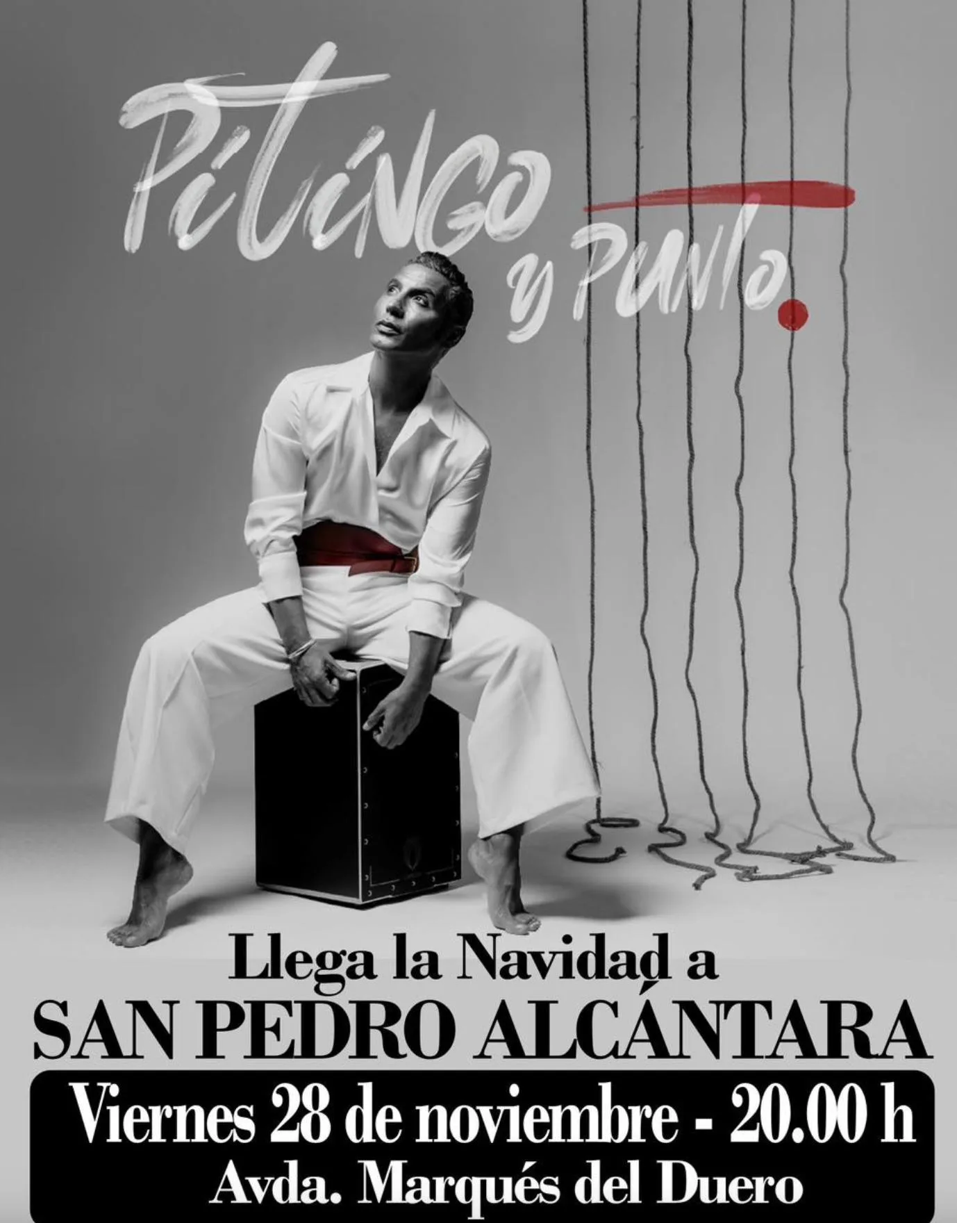 Black-and-white poster for Pitingo’s concert: the singer sits barefoot on a cajón wearing an all-white outfit and looking upwards; at the top it says “Pitingo y punto” in handwritten letters with a red brush stroke, and at the bottom the text reads “Christmas arrives in San Pedro Alcántara – Friday 28 November, 8:00 p.m., Avda. Marqués del Duero”.