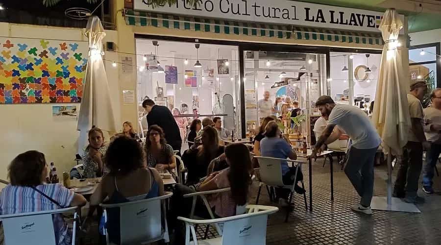 People gathering for a cultural event and live performance at Centro Cultural La Llave in Málaga.